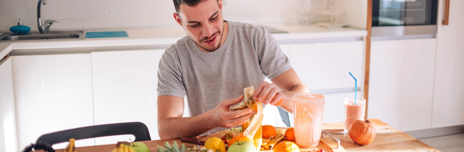 Man sitting at the kitchen table preparing a healthy meal - Nutrition in Recovery - Ingrained Recovery