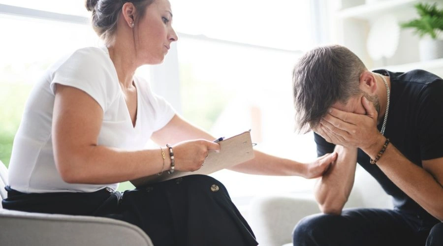 Distraught man with hands on face - Will I Be Fired for Taking FMLA to Go to Rehab?