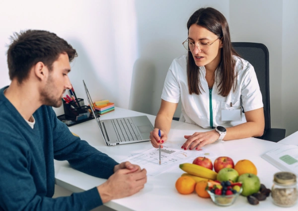 The Connection Between Nutrition and Recovery Dietician showing a patient nutrition advice - The Connection Between Nutrition and Recovery
