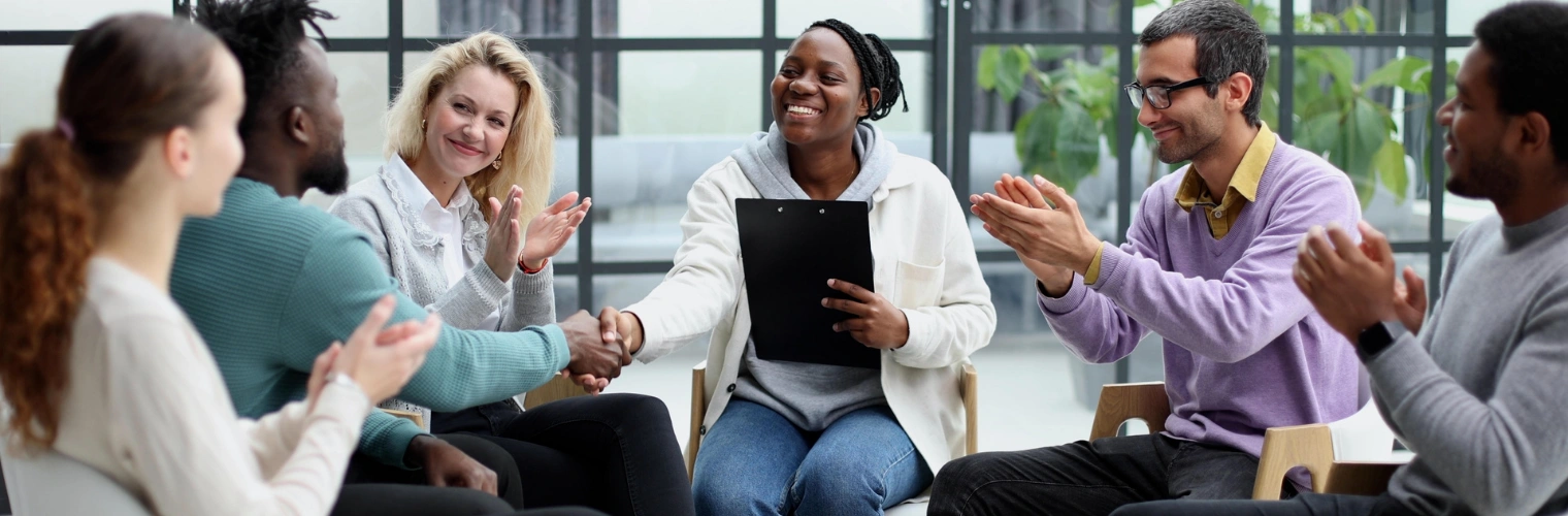 Group of individuals engaging in a supportive and open discussion at an NA meeting