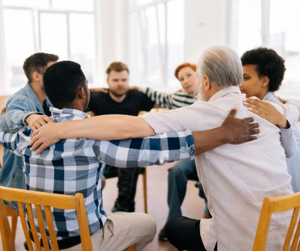 Group of people sitting in circle during AA Meeting