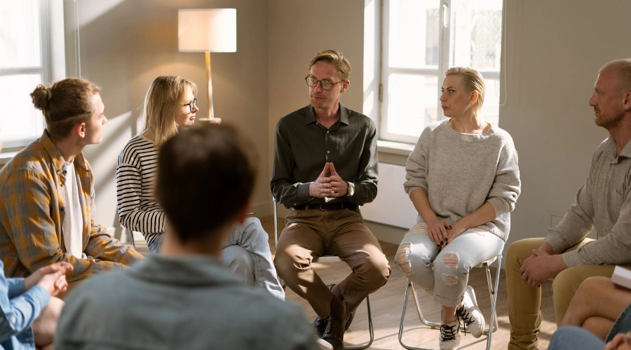 Image of a group of adults attending an AA meeting