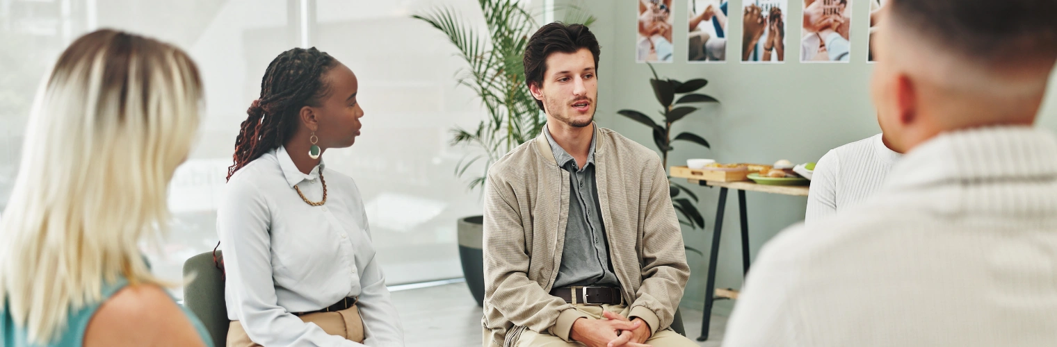 Image of man speaking in a group circle at an NA meeting
