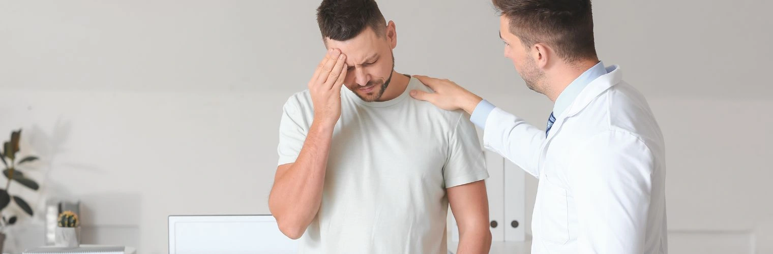 Image of a male physician consoling a male patient - Xanax and Alcohol Abuse - Ingrained Recovery