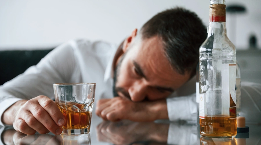 Image of a man holding a glass of alcohol