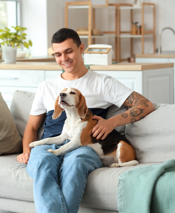 Image of a man playing with his dog, symbolizing emotional support and improved well-being in pet-friendly rehab