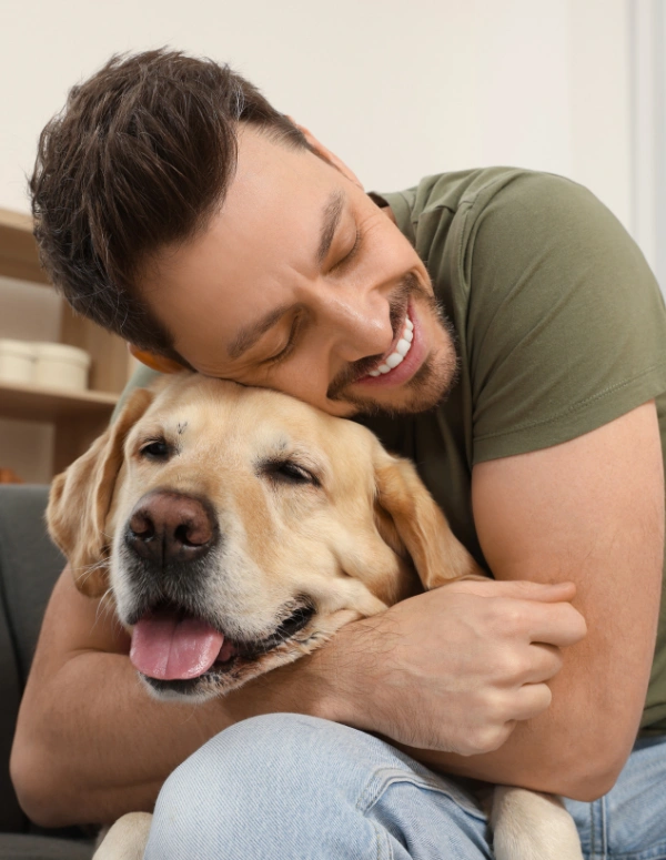 Image of a man with his dog at a pet-friendly rehab center