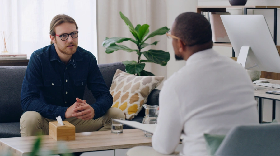 Image of a man sitting in therapy with a counselor