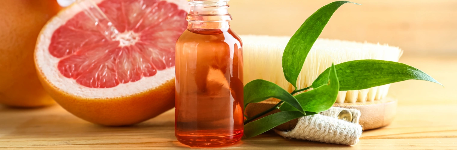 Grapefruit essential oil supporting mood balance and reducing cravings during recovery Image of a grapefruit and grapefruit essential oil, which supports mood balance and reducing cravings during recovery