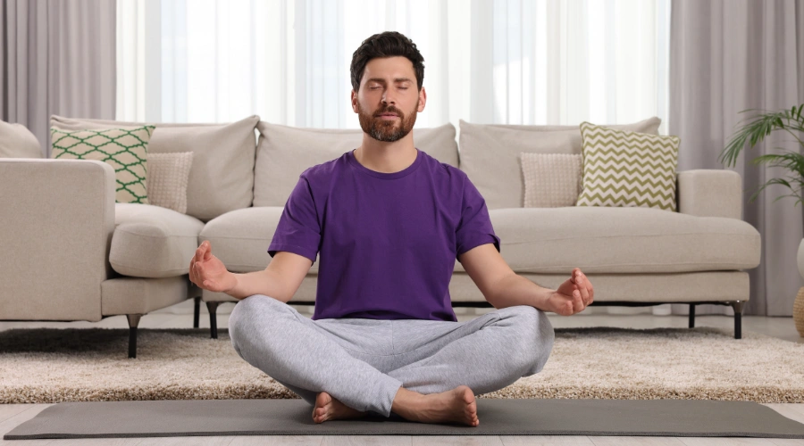 Image of a man in a calm, meditative pose practicing prayer and mindfulness