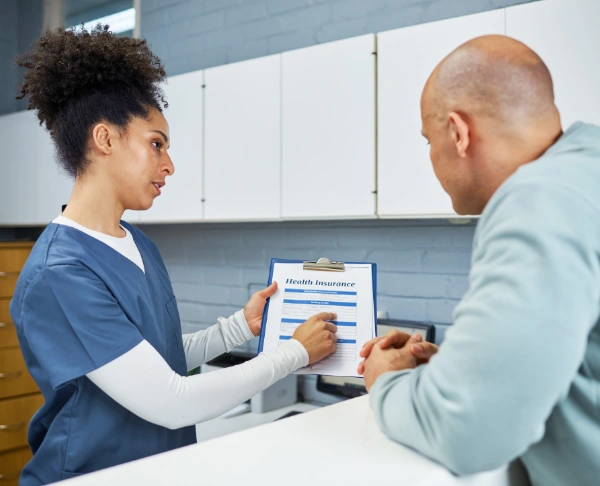 Image of insurance coordinator assisting a patient with rehab coverage details