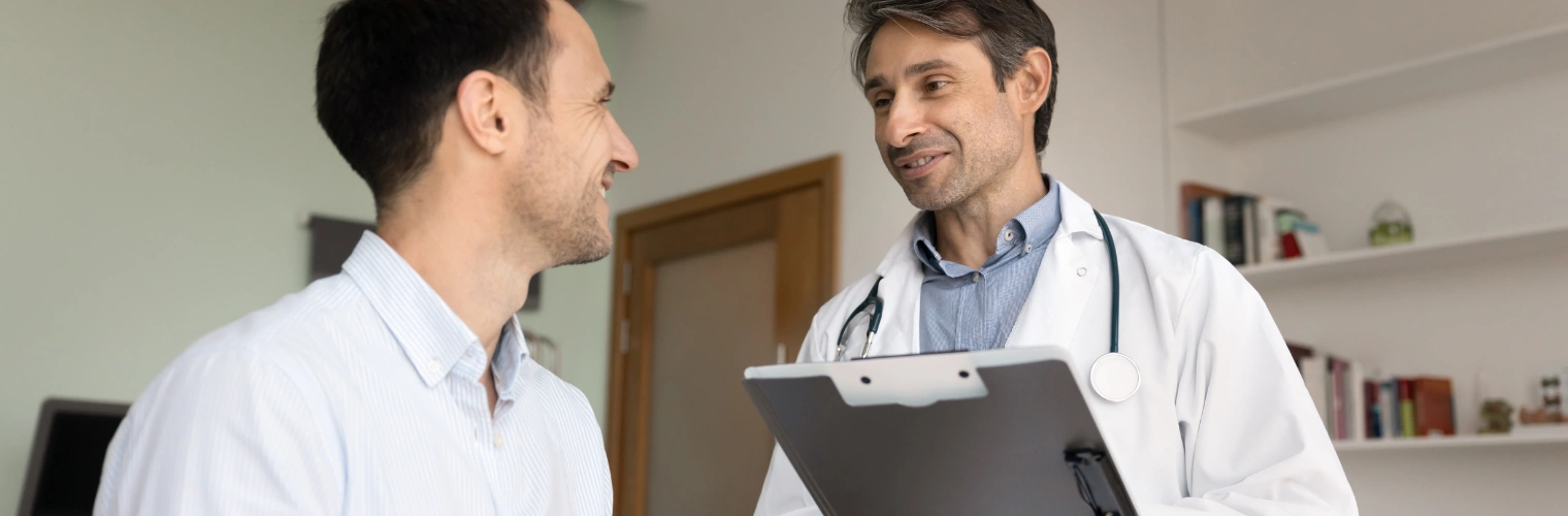 Image of a man reviewing rehab options with a counselor