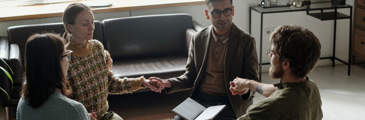 Image of men and women in a small circle at an AA meeting Image of men and women in a small circle at an AA meeting