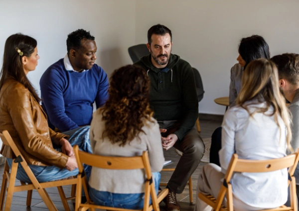 Cocaine Anonymous Atlanta - Ingrained Recovery Image of men and women sitting in a circle at a Cocaine Anonymous meeting - Cocaine Anonymous Atlanta - Ingrained Recovery