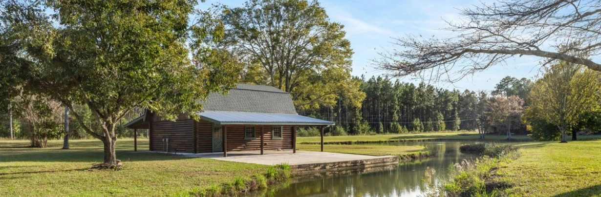 Exterior view of Ingrained Recovery’s peaceful 50-acre campus in Eastman, Georgia, offering residential treatment and detox for substance use recover Exterior view of Ingrained Recovery’s tranquil 50-acre campus in Eastman, Georgia, offering residential treatment and detox for substance use recovery