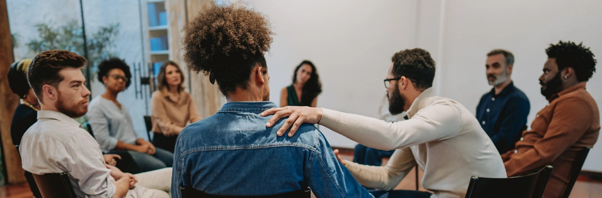 Image of support group members sitting together in a circle Image of support group members, both men and women, sitting together in a circle