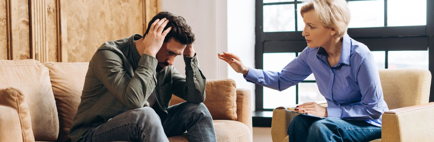 Image of a man in addiction treatment talking to his counselor Image of a man in addiction treatment talking to his counselor