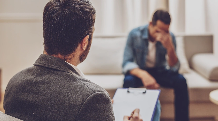 Image of man meeting with a rehab counselor
