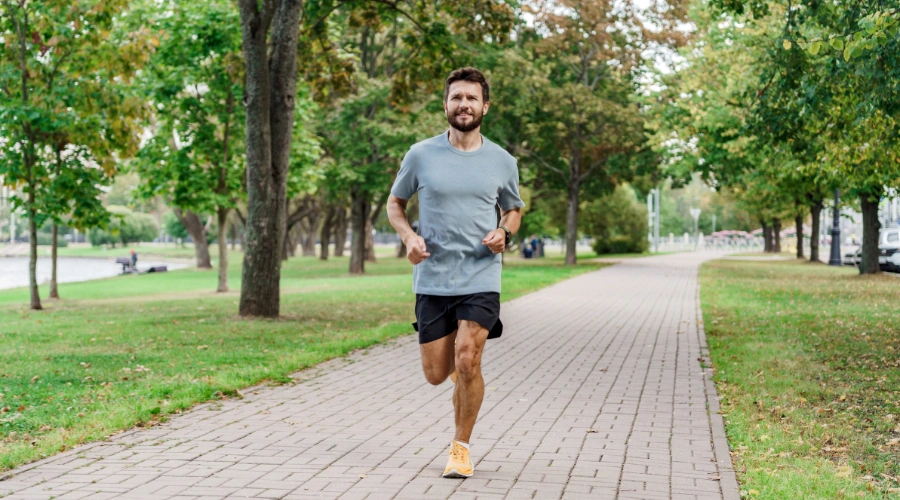 Image of a Person exercising outdoors, showing improved mood and mental well-being through physical activity