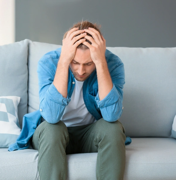 Image of a young adult looking stressed and withdrawn at home, highlighting struggles with failure to launch, mental health challenges Image of a young adult lmale ooking stressed and withdrawn at home, highlighting his failure to launch, struggles and mental health challenges