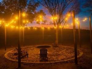 fire-pit-at-dusk-with-string-lights-ingrained-georgia The fire pit at Ingrained Recovery is lit up with string lights at dusk