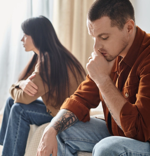 Image of couple looking stressed and distant Image of couple sitting apart from each other on a sofa, looking distant and unhappy