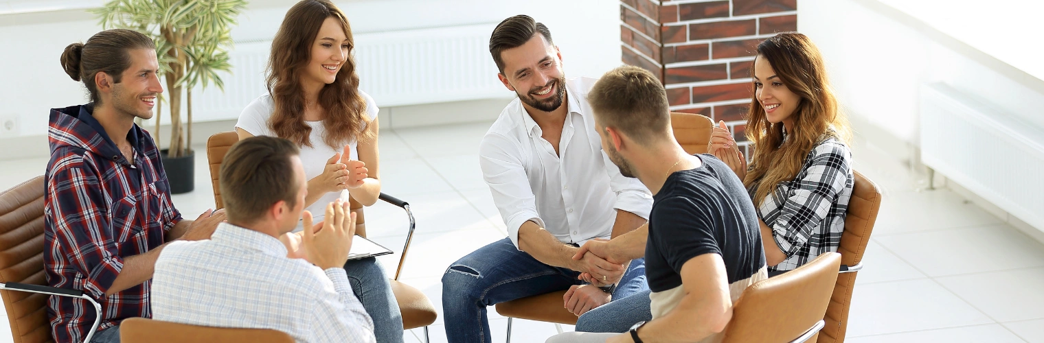 Image of group of people participating in a structured group therapy session Image of a group of men and women participating in a structured group therapy session