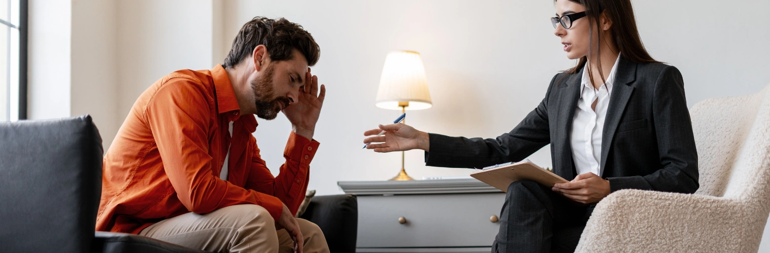 Image of person speaking with a therapist during alcohol use disorder treatment Image of a man speaking with a therapist during alcohol use disorder treatment