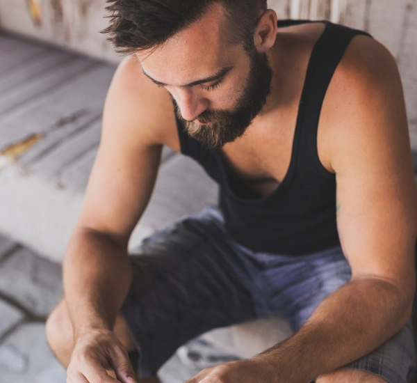 Image of a person sitting on a couch experiencing dizziness and nausea during an acute cannabis overdose or greening out episode Image of a person sitting on a couch experiencing dizziness and nausea during an acute cannabis overdose or greening out episode