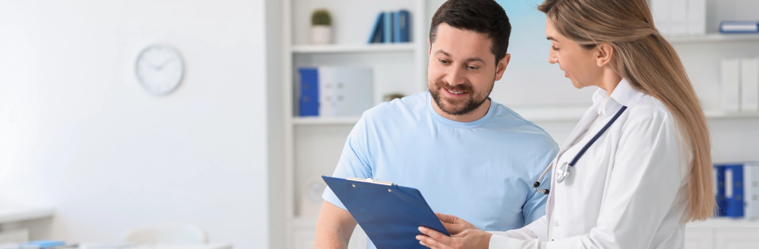 Image of a doctor checking in on a patient in a comfortable treatment room Image of a doctor checking in on a patient in a comfortable treatment room
