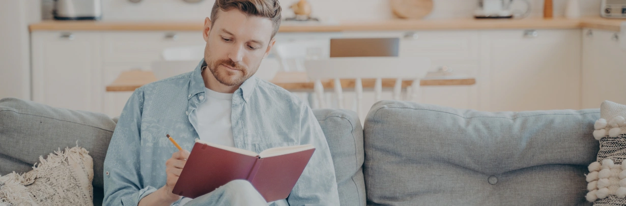 Image of a person making a handwritten list in a notebook Making Amends in AA - Image of a person making a handwritten list in a notebook