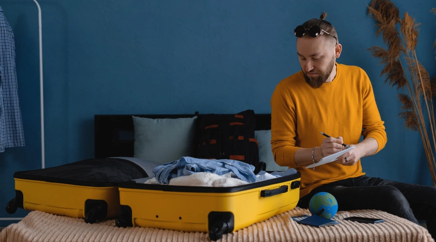 Image of a person preparing a checklist and packing for traveling to out-of-state rehab treatment
