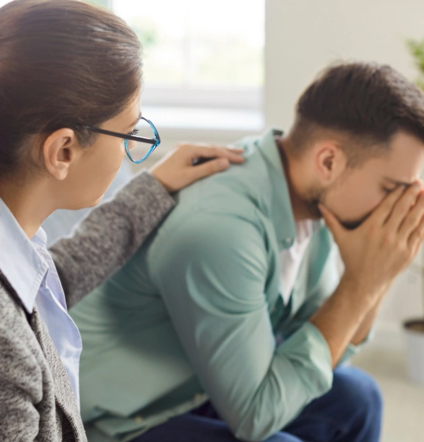 Image of a therapist having a supportive conversation with a client in a counseling room Image of a therapist having a supportive conversation with a client in a counseling room