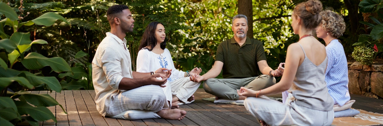 Image of a small group participating in a guided outdoor grounding exercise Woodland Therapy and Nature-Based Recovery at Ingrained Recovery